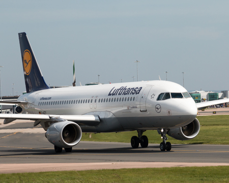 Lufthansa A319-100 narrow-body passenger plane (D-AIZY) taxiing on Manchester International Airport tarmac.のeditorial素材