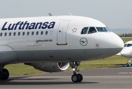 Lufthansa A319-100 narrow-body passenger plane (D-AIZY) taxiing on Manchester International Airport tarmac.のeditorial素材