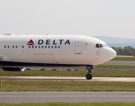 Delta Air Lines Boeing 767-332(ER) wide-body passenger plane (N180DN) taxiing on Manchester International Airport tarmac.のeditorial素材