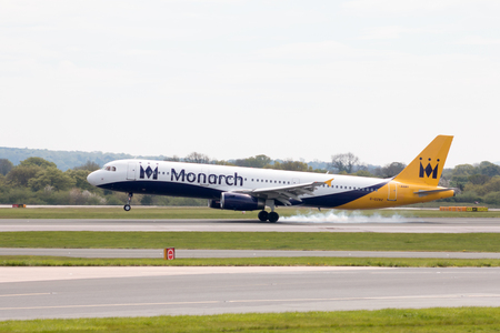 Monarch Airlines Airbus A320-231 narrow-body passenger plane landing to Manchester International Airport runway.のeditorial素材