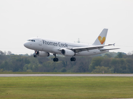 Thomas Cook Airlines Airbus A320-233 narrow-body passenger plane (LY-VEI) landing to Manchester International Airport runway.のeditorial素材