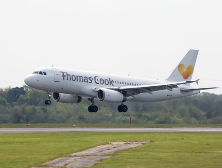 Thomas Cook Airlines Airbus A320-233 narrow-body passenger plane (LY-VEI) landing to Manchester International Airport runway.のeditorial素材