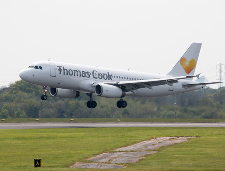 Thomas Cook Airlines Airbus A320-233 narrow-body passenger plane (LY-VEI) landing to Manchester International Airport runway.のeditorial素材