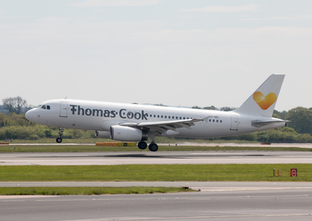 Thomas Cook Airlines Airbus A320-233 narrow-body passenger plane (LY-VEI) landing to Manchester International Airport runway.のeditorial素材