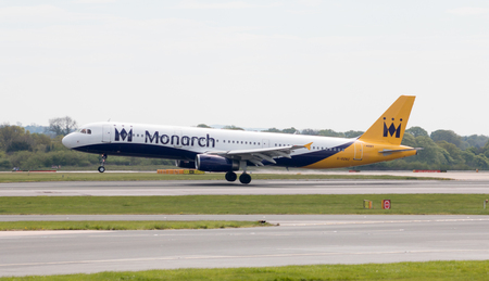 Monarch Airlines Airbus A320-231 narrow-body passenger plane landing to Manchester International Airport runway.のeditorial素材