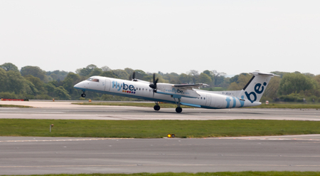 Flybe Bombardier Dash 8 Q400 twin-engine, medium range, turboprop passenger plane (G-JECP) taking off from Manchester International Airport runway.のeditorial素材