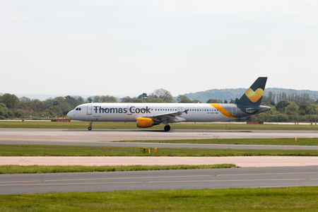Thomas Cook Airlines Airbus A321-211 wide-body passenger plance (G-TCDZ) taking off from Manchester International Airport runway.のeditorial素材