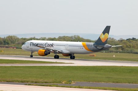 Thomas Cook Airlines Airbus A321-211 wide-body passenger plance (G-TCDZ) taking off from Manchester International Airport runway.のeditorial素材