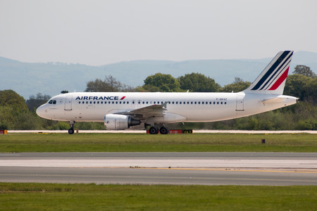 Air France Airbus A320 narrow-body passenger plane (F-GKXZ) taxiing on Manchester International Airport tarmac.のeditorial素材