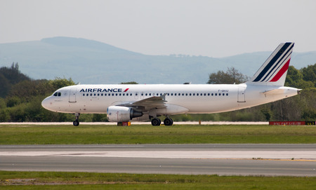 Air France Airbus A320 narrow-body passenger plane (F-GKXZ) taxiing on Manchester International Airport tarmac.のeditorial素材