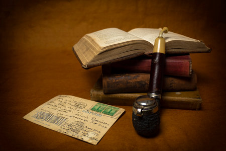 Old books with old postcard and vintage smoking pipeの写真素材