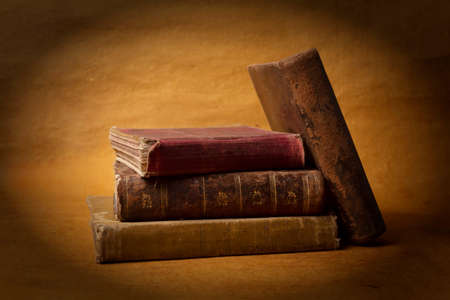 Old books stacked on a brown backgroundの写真素材