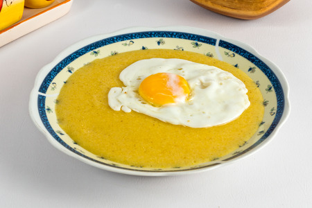 Cornmeal dish with a fried eggの写真素材