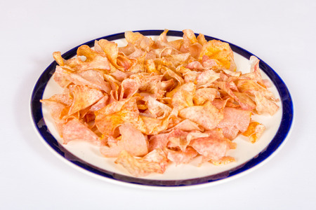 A dish of fried taro slices on a white backgroundの写真素材