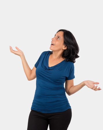 Astonished womand,with open arms and open mouth, she is wearing a blue blouseの写真素材