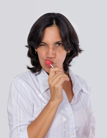 A woman girl with a candy in her handの写真素材