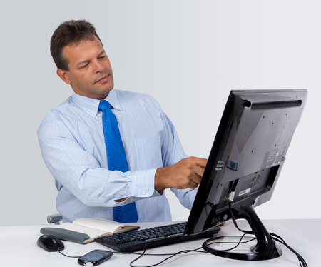 A man wearing blue shirt  with a computerの写真素材