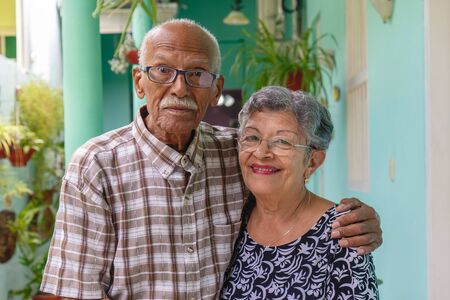 An smiling elderly couple, both wearing glasses.の写真素材