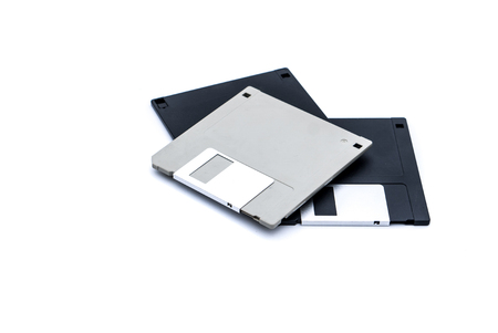 Obsolete floppy disks one grey two black were an old form of data storage or expanded memory in computer systems.の写真素材