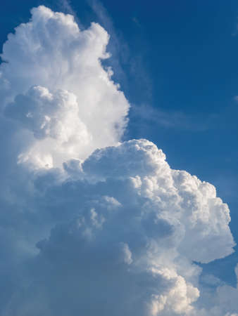 Dark blue sky and puffy cumulonimbus cloudsの写真素材
