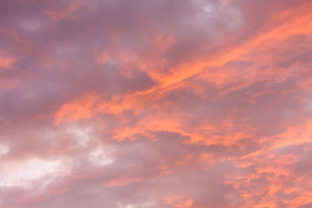 Cloudy sky at sunrise or sunset with pink and orange tonesの写真素材