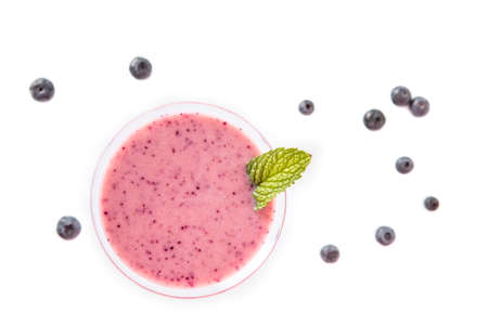 Blueberry smoothie cup with several blueberries on a white background. Top view-の写真素材