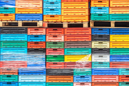 Colored plastic boxes stacked in a fishing port. Colorful background of cargo containers.の写真素材