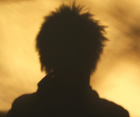Spiky hair silhouette off wall