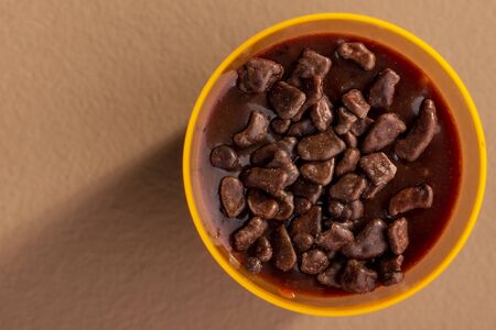 acrylic cup with brigadeiro and chocolate sprinkles on brown background.の写真素材