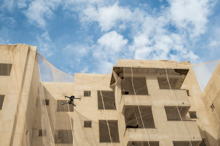 dji mavic 2 pro flying next to building under constructionのeditorial素材