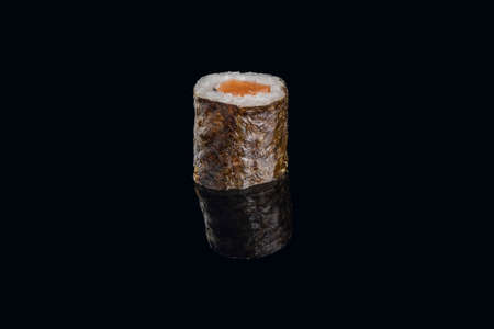 salmon sushi wrapped with seaweed isolated on black background.の写真素材