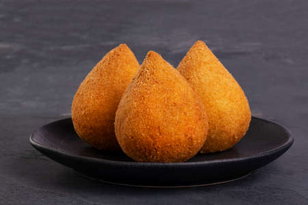 Traditional fried coxinha stuffed with chicken and a glass of cold soda.の写真素材