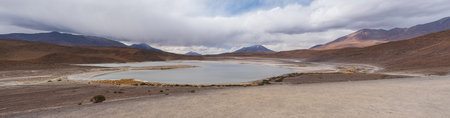 Stunning landscape of lagoon and mountains in the Bolivian Altiplano. Panoramic view of the Bolivian Altiplano in Eduardo Avaroa Andean Fauna National Reserve in Bolivia.の写真素材