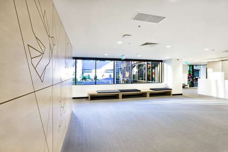 Empty waiting room with space and windows showed outside over the benches and hallway from the side
