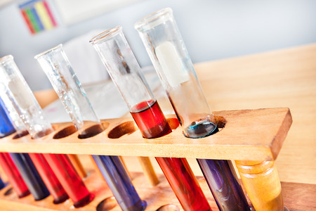 Science laboratory equipments including sample test tubes in a rack with blue and red liquid showed as a closeup with bllurred backgroundの写真素材