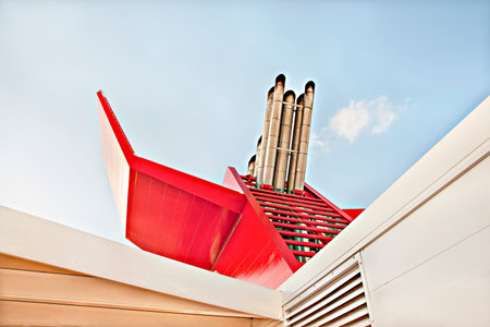 Smoke pipes of a big ship and sky, sunlight arround the area, natural view closeup, daytime scene, walls are red color, clouds are white.の写真素材