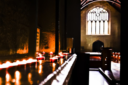 Darkroom illuminated by small flashing candles with sunlight came through the windowのeditorial素材