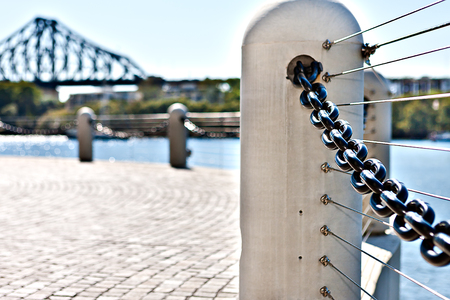 Close view of a modern concrete pillar fence with metal chain fixed to the riverside street of  Brisbane City, Queensland, Australia.のeditorial素材