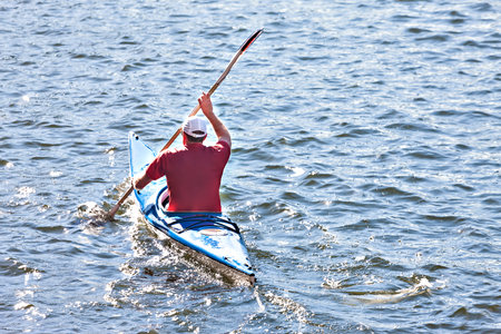 Man riding boat on the  river with blue water waves