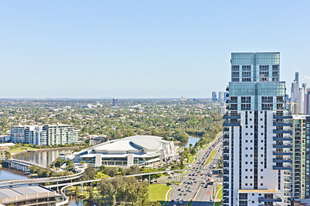 Bridge with lake and roads near city view, roads have vehicles, river and green trees beside buildings with sky, sun shine is very shiny, lake side with clear water arround city , green trees near lake water, luxury looking business hotels and buildings, sky view is very beautiful.の写真素材