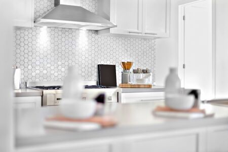 Kitchen with a blurred items and focusing some utensils beside a  door which spread sunlight from the outside, very clean place also perfect lightning.の写真素材