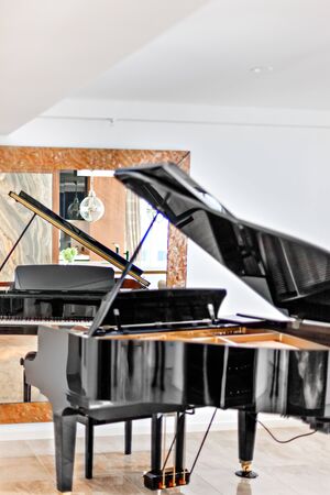 A grand piano with a mirror in the backgroundの写真素材