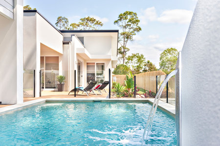 Luxury pool side near modern home entrance, shiny sunlight arround the area, beautiful green trees...