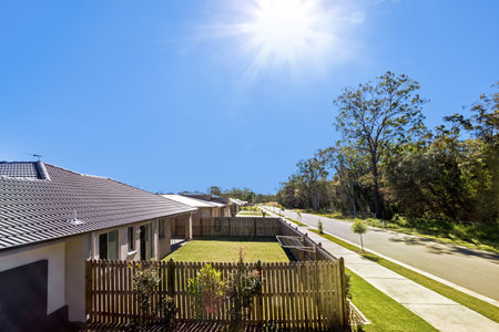 A house exterior featuring a garden and a wooden boundary