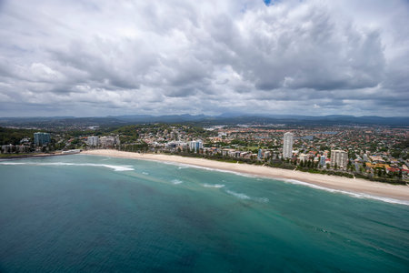 Long beach stretching in front of a huge modern city, Surfers Paradise, Queensland, Australiaの写真素材