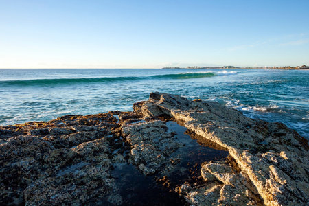 Ocean waves crashing to the rocky shore of Currumbin, Gold Coast, Australia