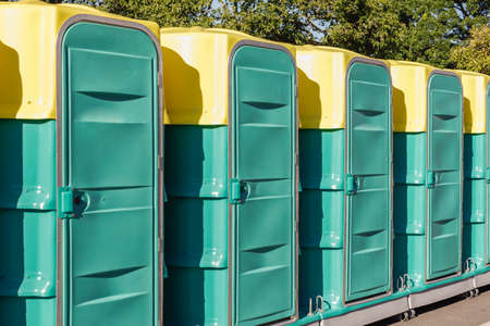 A row of green mobile toilet cabinの写真素材