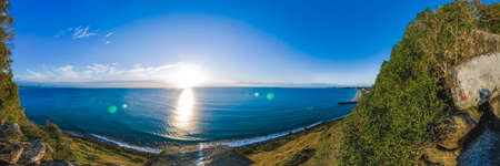 Panoramic view of sun over the ocean horizonの写真素材