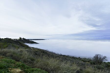 sea ?? of ?? clouds over churchの写真素材