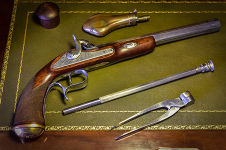 old pistol with equipment magazine powder